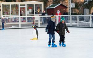 two-children-inside-of-ice-skating-field-1722444